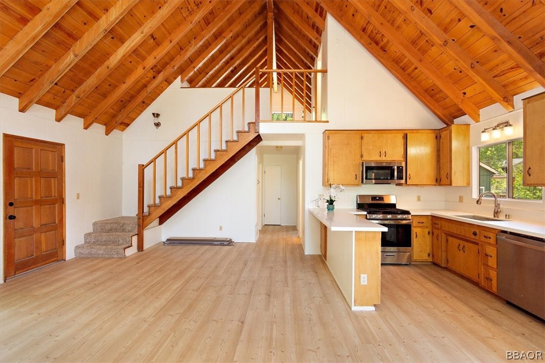 420 Lark Road Wrightwood, CA 92397 - Photo 6 of 25 a open kitchen with stainless steel appliances granite countertop a stove and a wooden floors