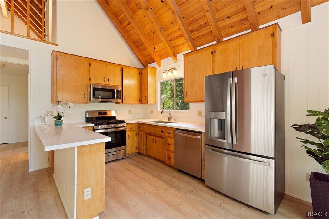 420 Lark Road Wrightwood, CA 92397 - Photo 7 of 25 a kitchen with stainless steel appliances a refrigerator stove microwave and sink