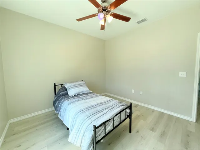 a bedroom with a bed and a ceiling fan