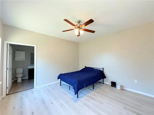 a living room with couch and a ceiling fan