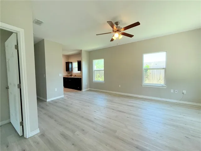 a view of a livingroom with a ceiling fan and window