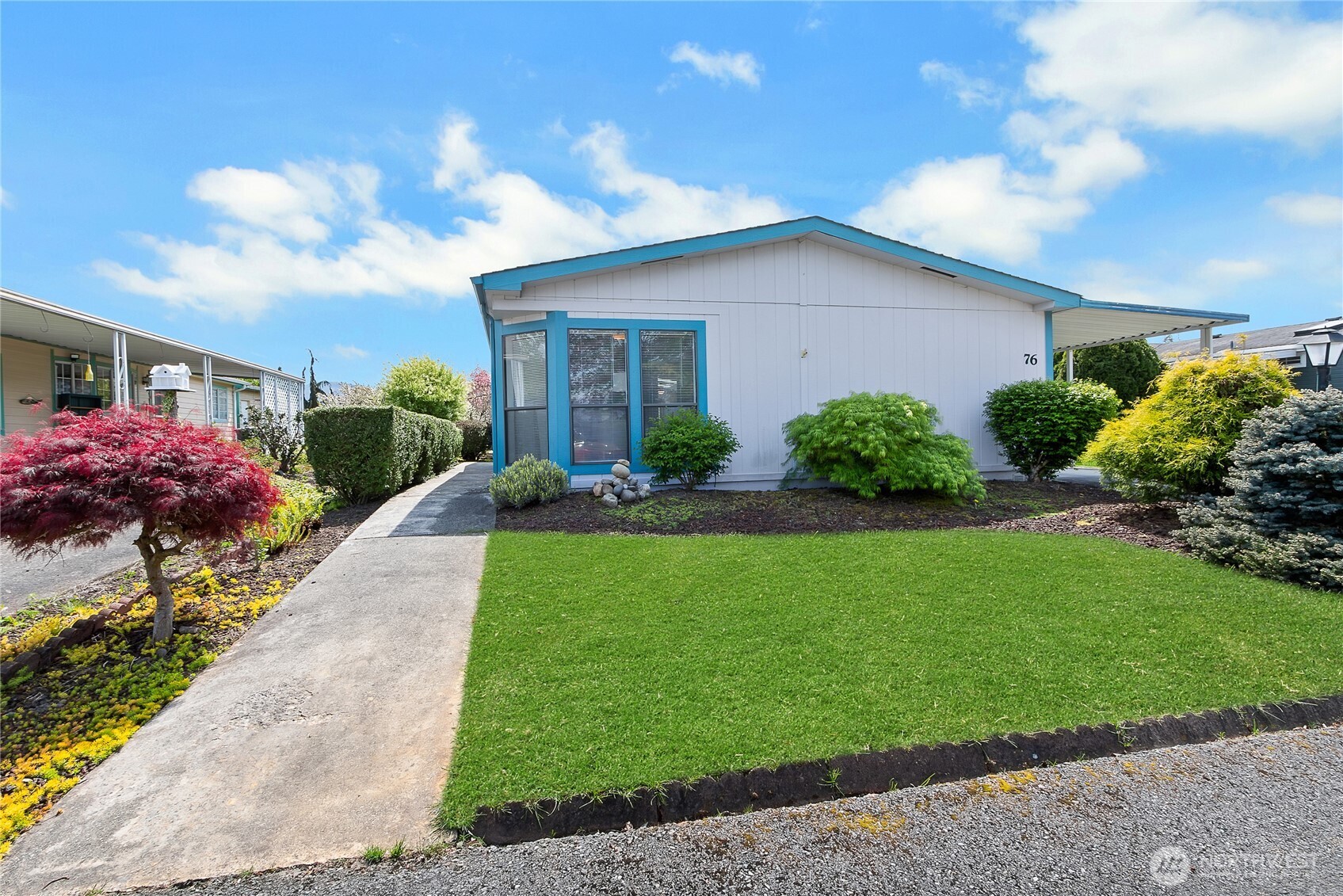 a front view of house with yard and green space