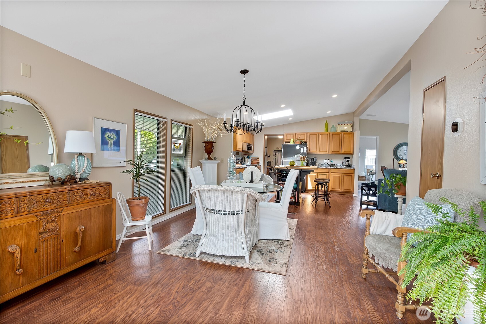 836 Harman Way South, Unit 76 Orting, WA 98360 - Photo 14 of 21 a living room with furniture dining table and a chandelier