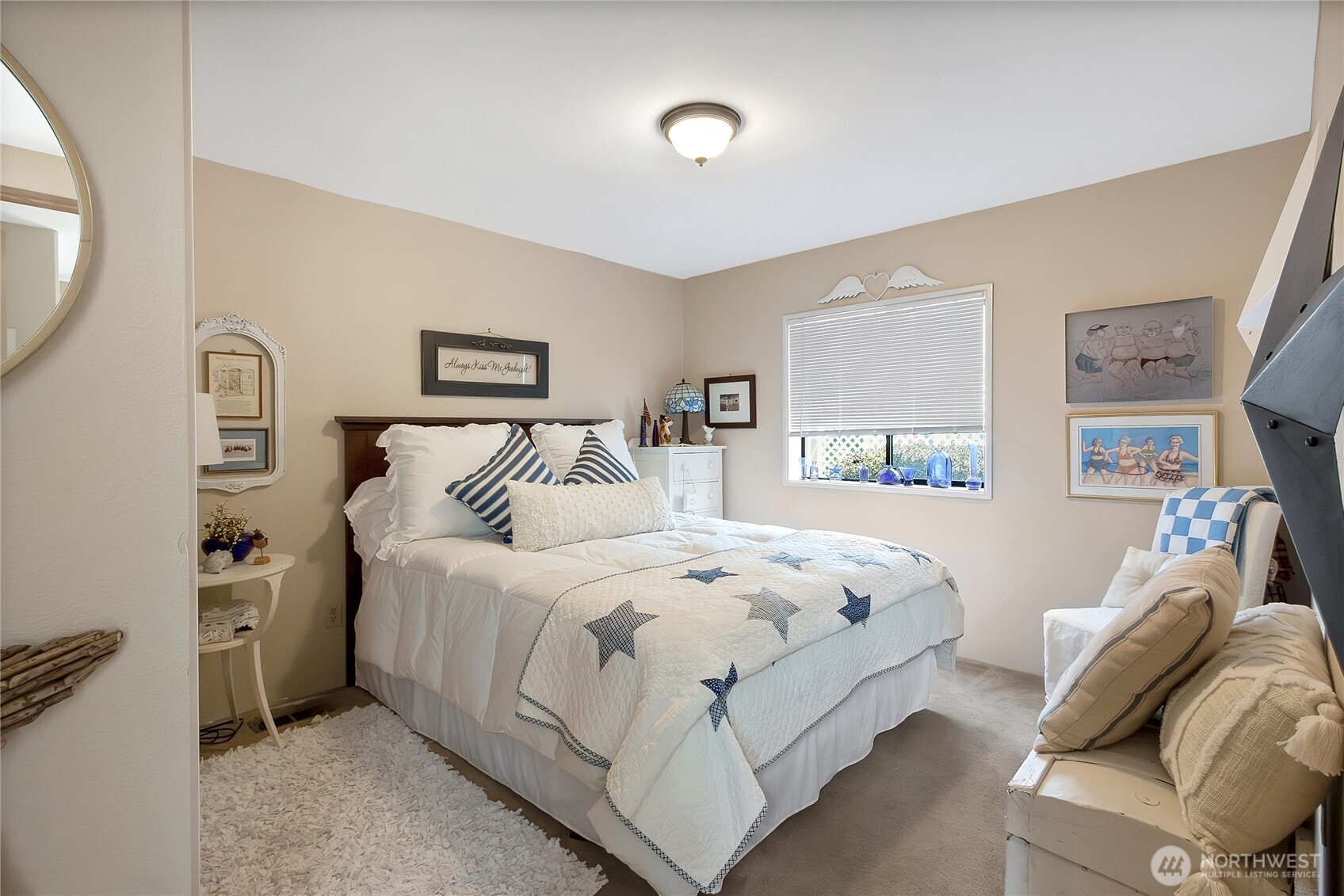 836 Harman Way South, Unit 76 Orting, WA 98360 - Photo 18 of 21 a bedroom with a bed and a mirror