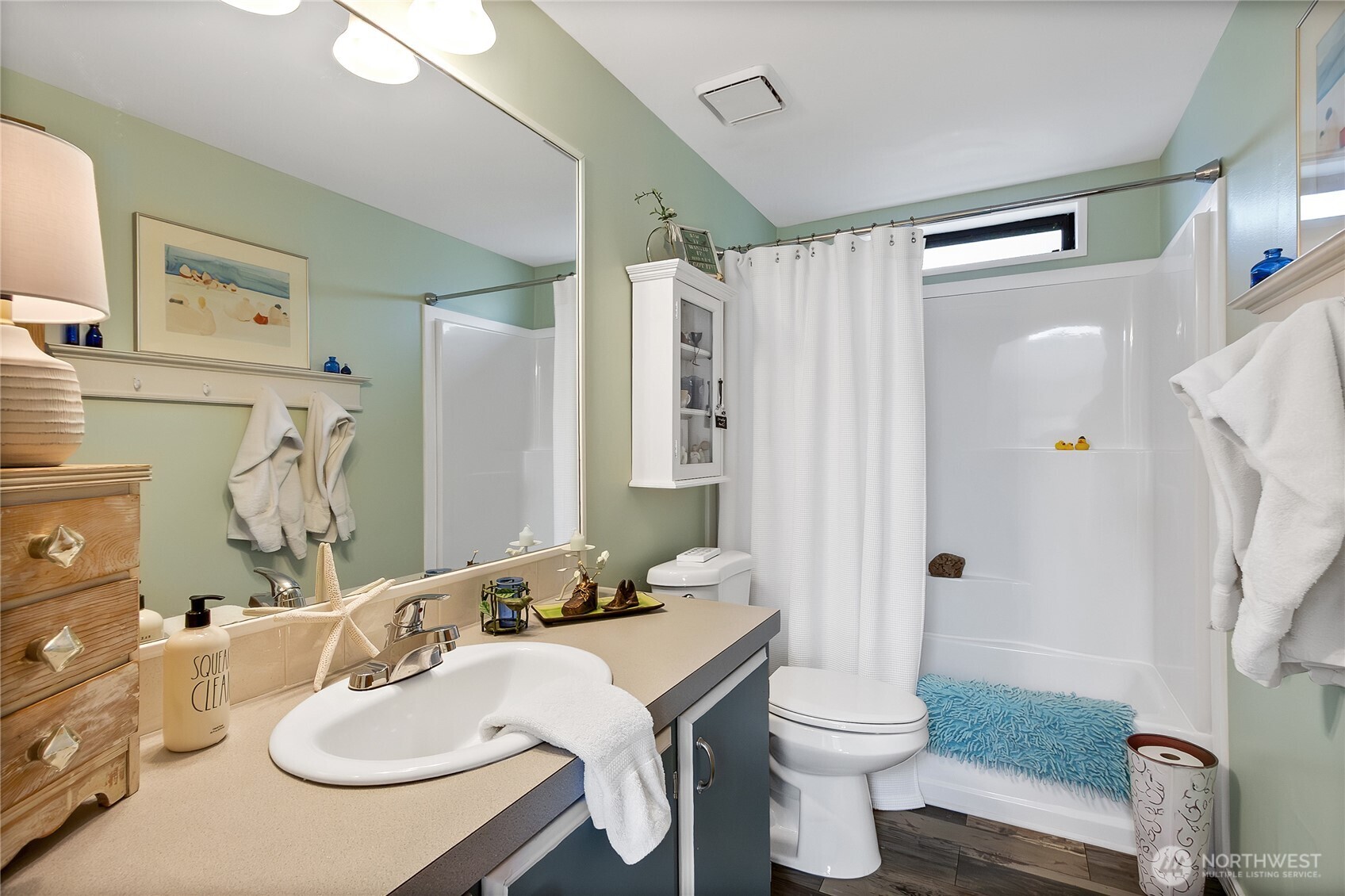 836 Harman Way South, Unit 76 Orting, WA 98360 - Photo 19 of 21 a bathroom with a sink toilet and shower