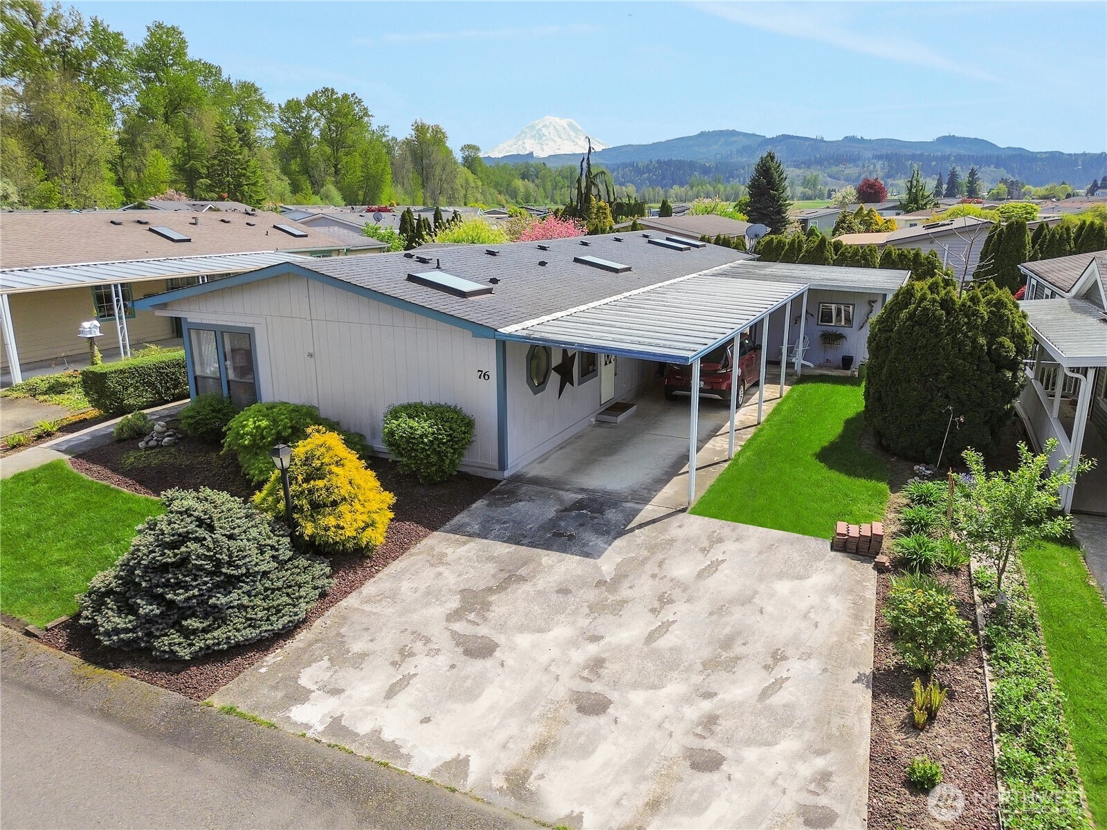 836 Harman Way South, Unit 76 Orting, WA 98360 - Photo 2 of 21 a view of a house with a yard and potted plants