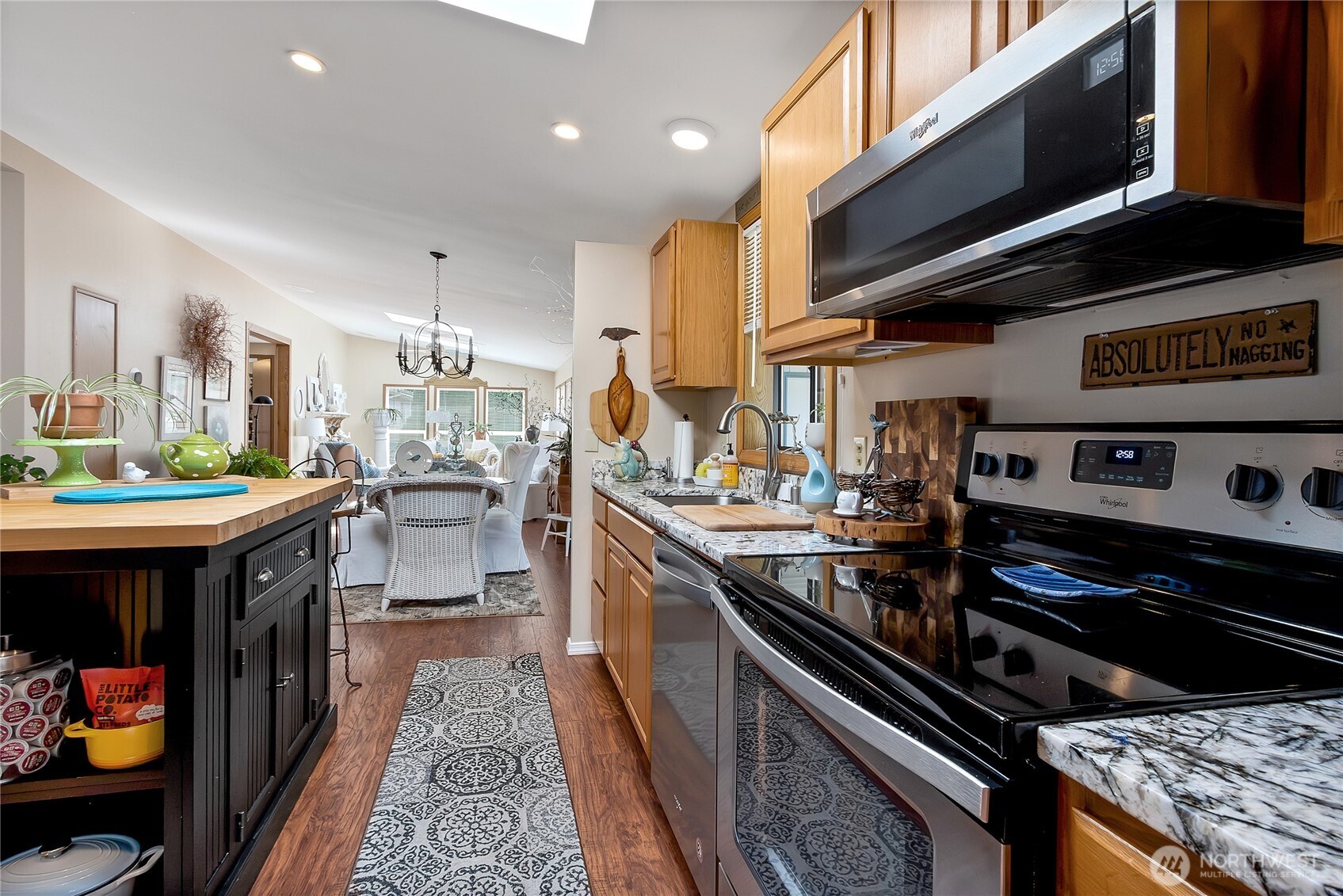 836 Harman Way South, Unit 76 Orting, WA 98360 - Photo 5 of 21 a kitchen with stainless steel appliances granite countertop a stove and a sink
