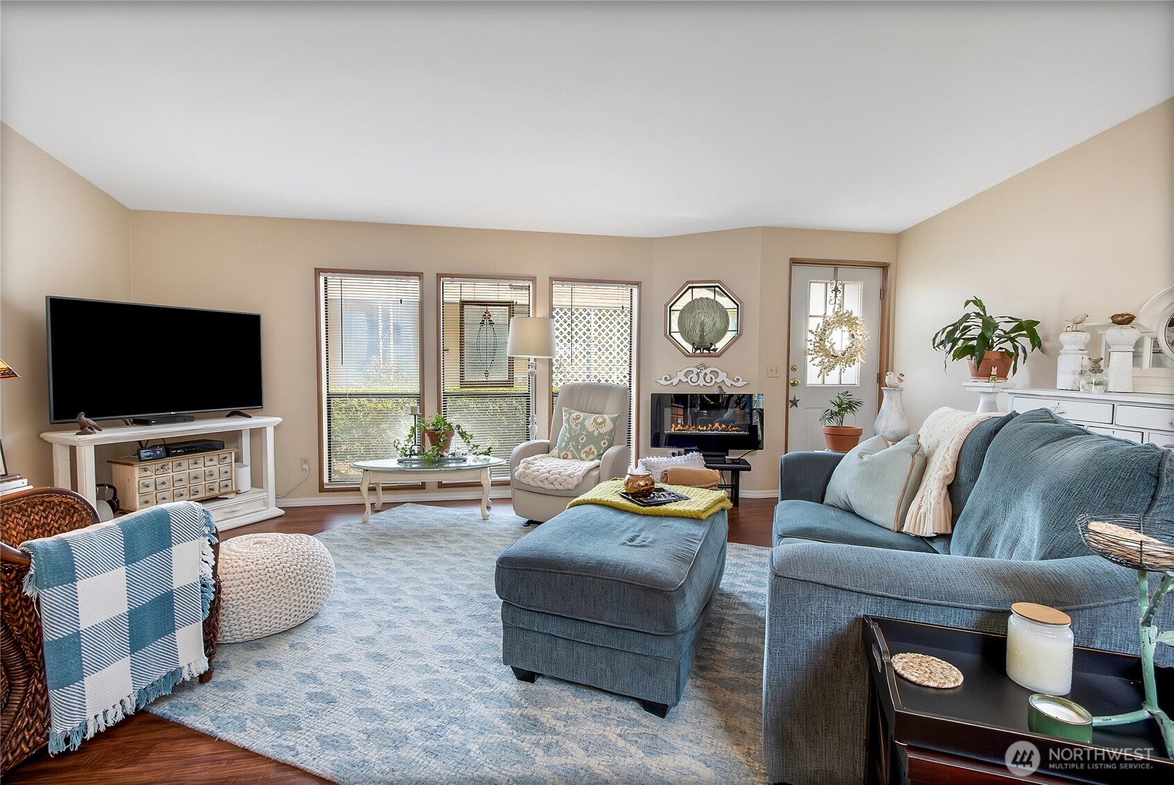 836 Harman Way South, Unit 76 Orting, WA 98360 - Photo 7 of 21 a living room with fireplace furniture and a flat screen tv