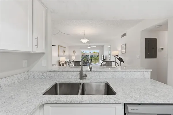 a kitchen with granite countertop a sink and cabinets