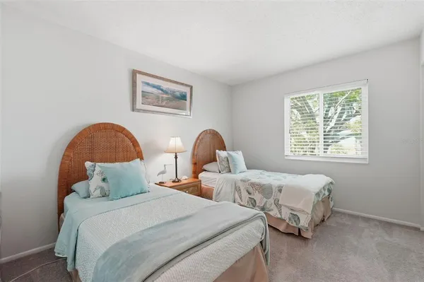 a bedroom with two beds and a window