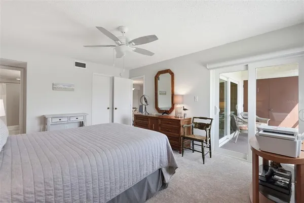 a bedroom with a bed a table and chairs