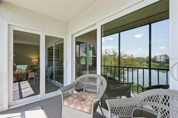 a balcony view with a couch and large windows