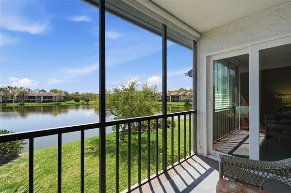 a view of a balcony with floor to ceiling windows with wooden floor