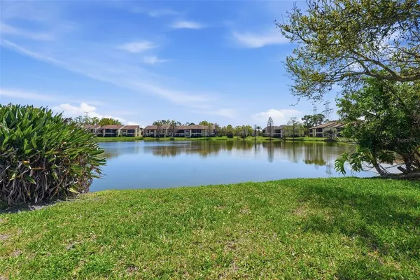 a view of a lake with houses in the back