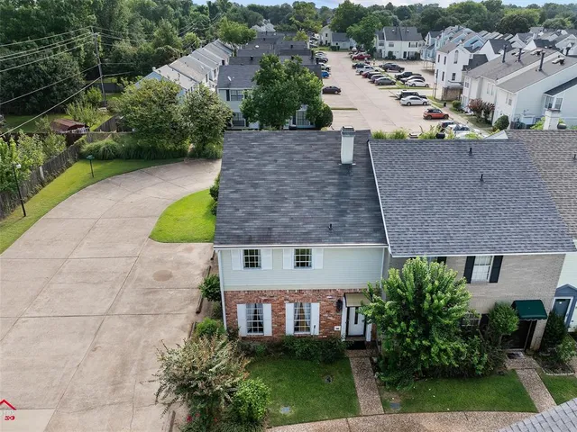 an aerial view of a house with a yard basket ball court and outdoor seating