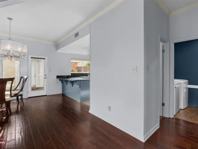 a view of a kitchen with furniture and wooden floor