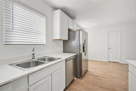 a kitchen that has a sink and a refrigerator