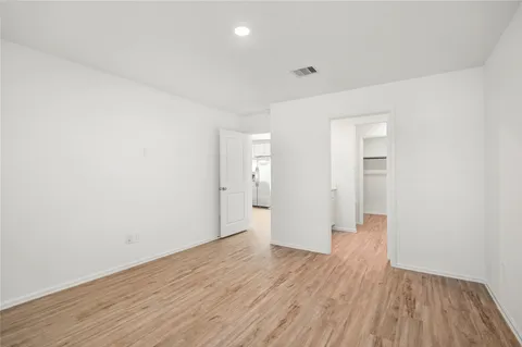 a view of wooden floor and windows in a room