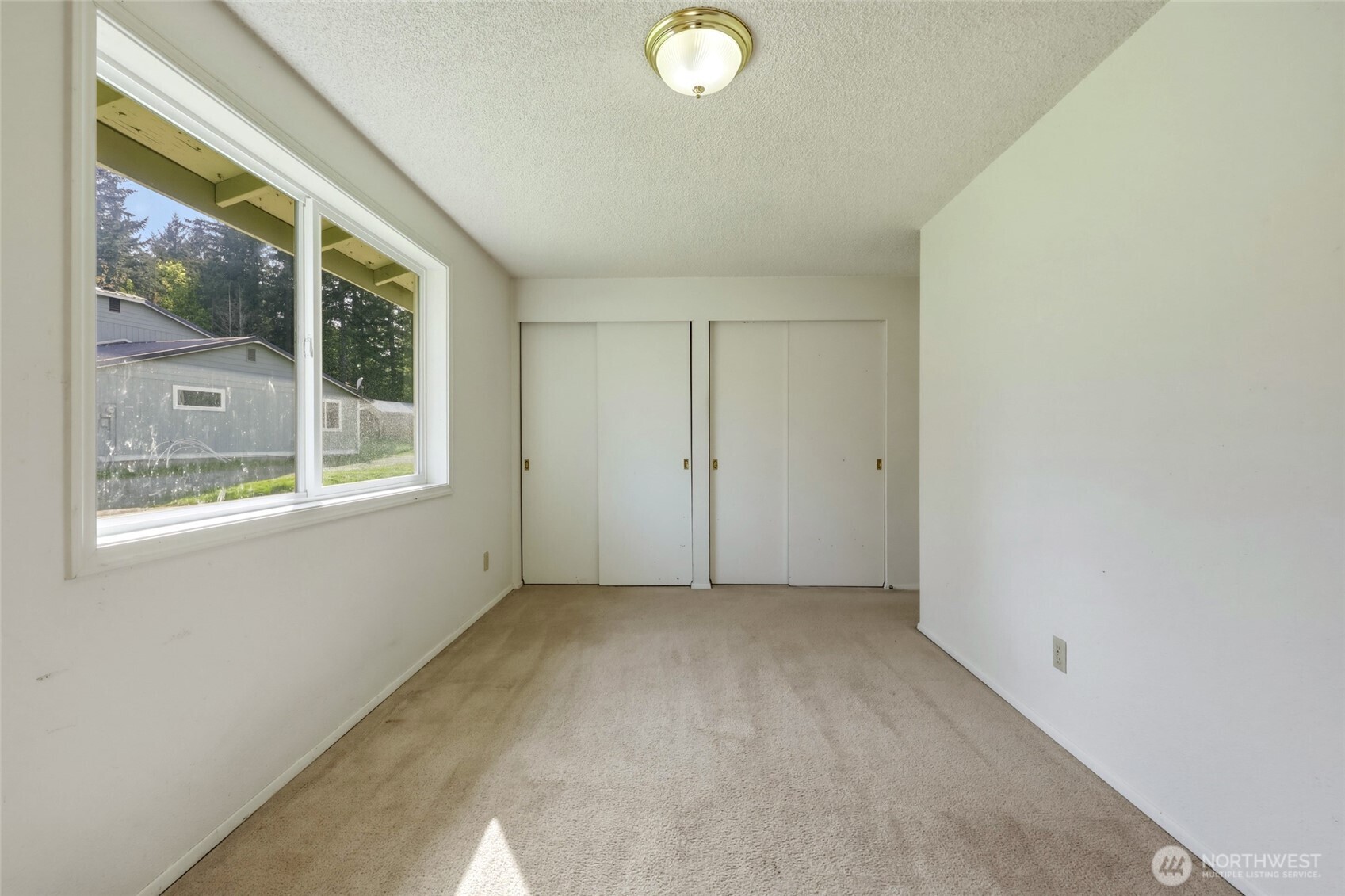 37214 Allen Road South Roy, WA 98580 - Photo 26 of 38 a view of a big room with windows and chandelier fan