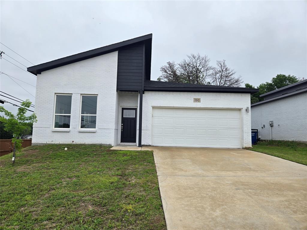 3202 Noor Street Dallas, TX 75233 - Photo 1 of 20 a view of a house with a yard and garage