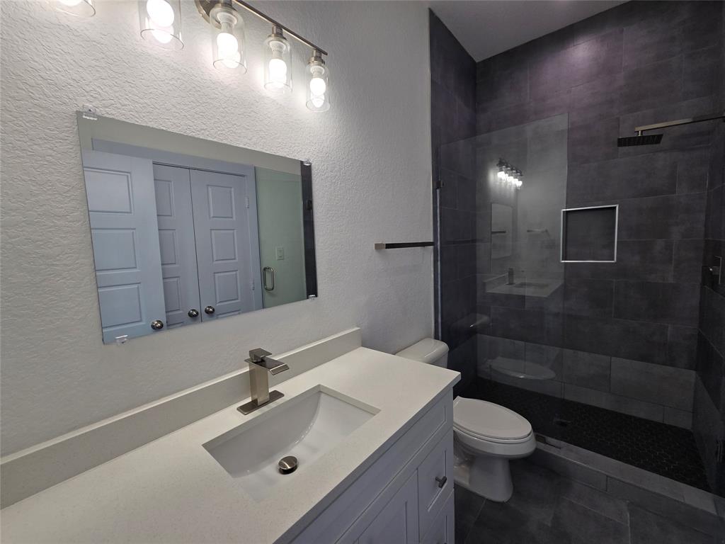 3202 Noor Street Dallas, TX 75233 - Photo 11 of 20 a bathroom with a sink a toilet and shower