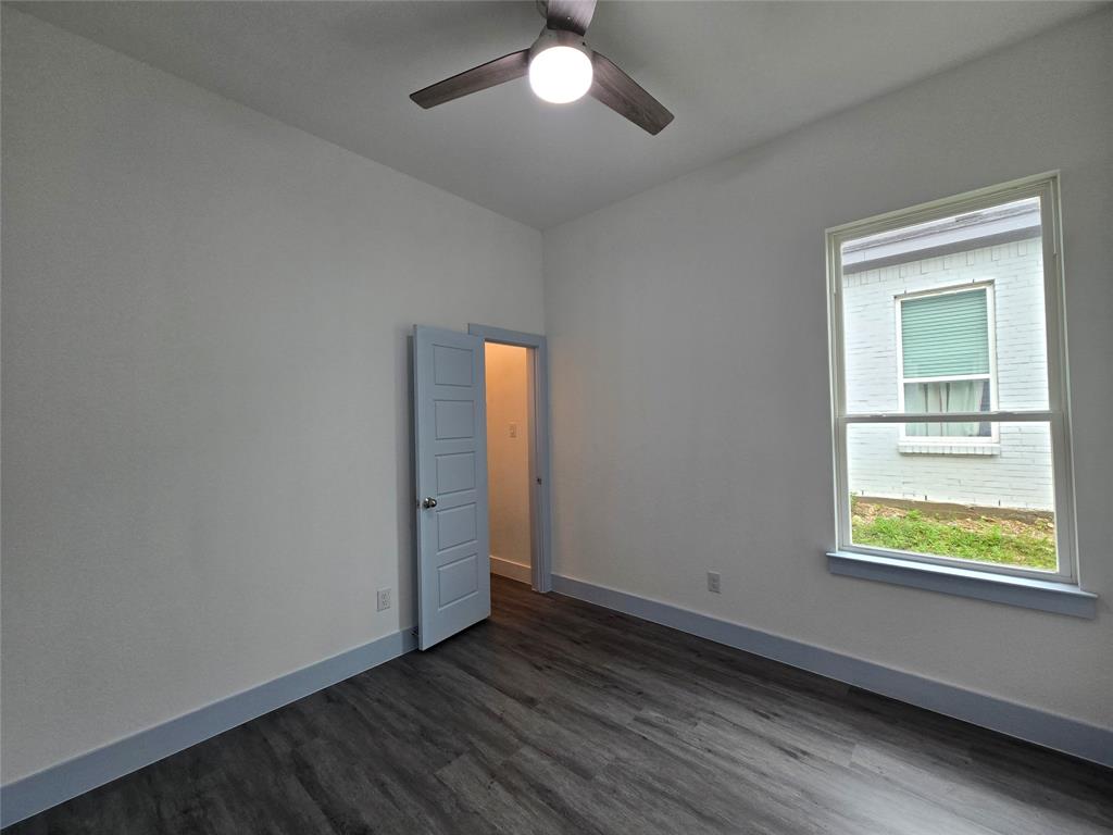 3202 Noor Street Dallas, TX 75233 - Photo 13 of 20 an empty room with wooden floor and windows