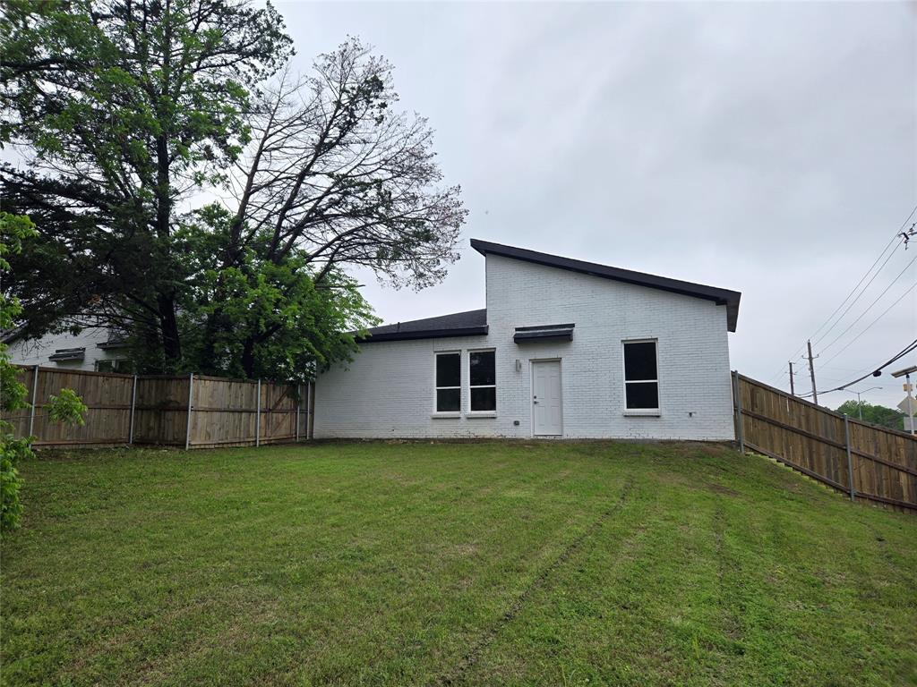 3202 Noor Street Dallas, TX 75233 - Photo 17 of 20 a backyard of a house with large trees and wooden fence