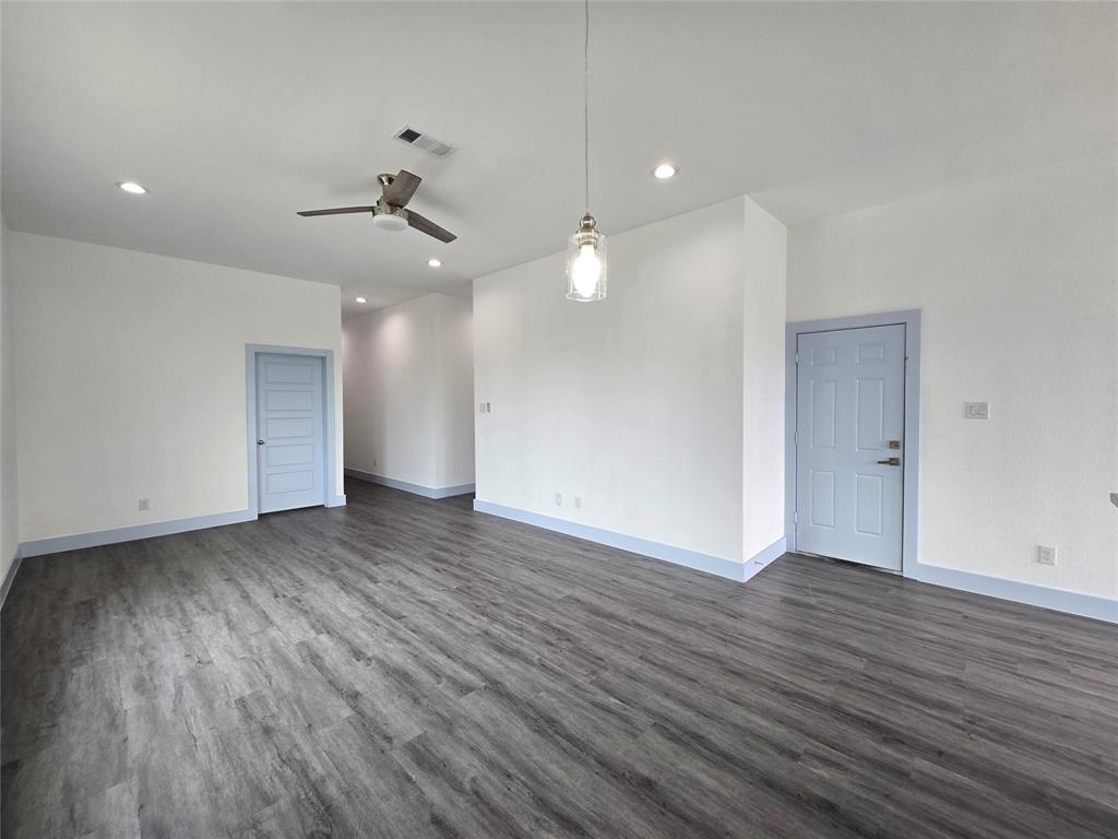 3202 Noor Street Dallas, TX 75233 - Photo 7 of 20 an empty room with wooden floor and windows