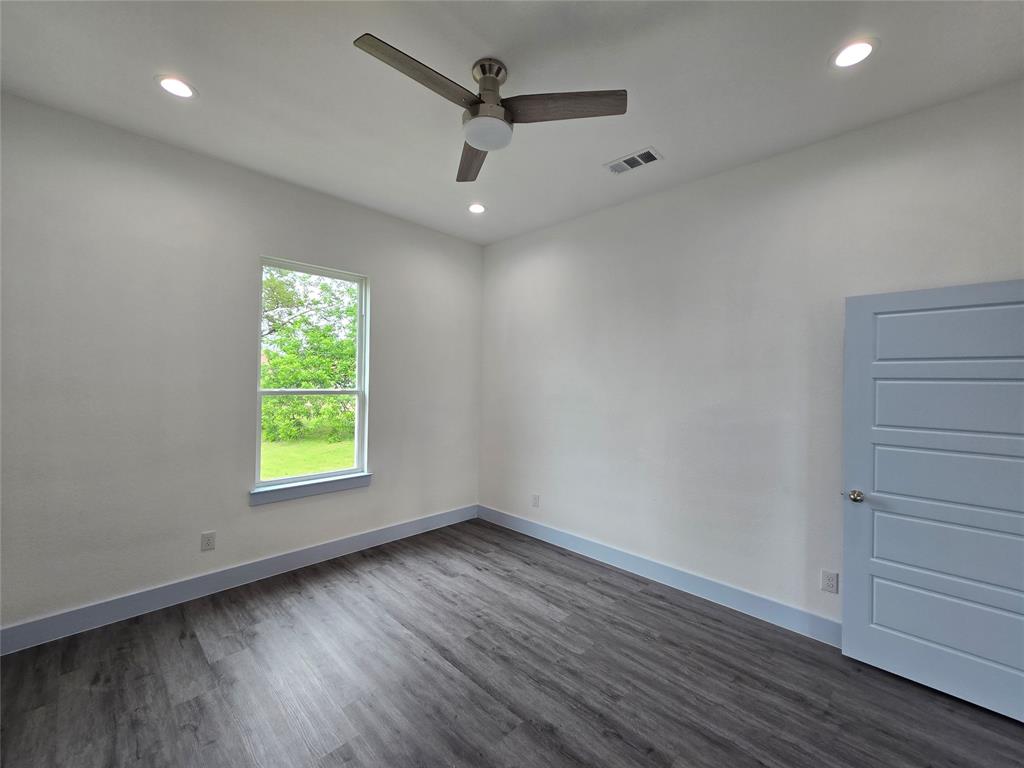 3202 Noor Street Dallas, TX 75233 - Photo 8 of 20 an empty room with a window and wooden floor