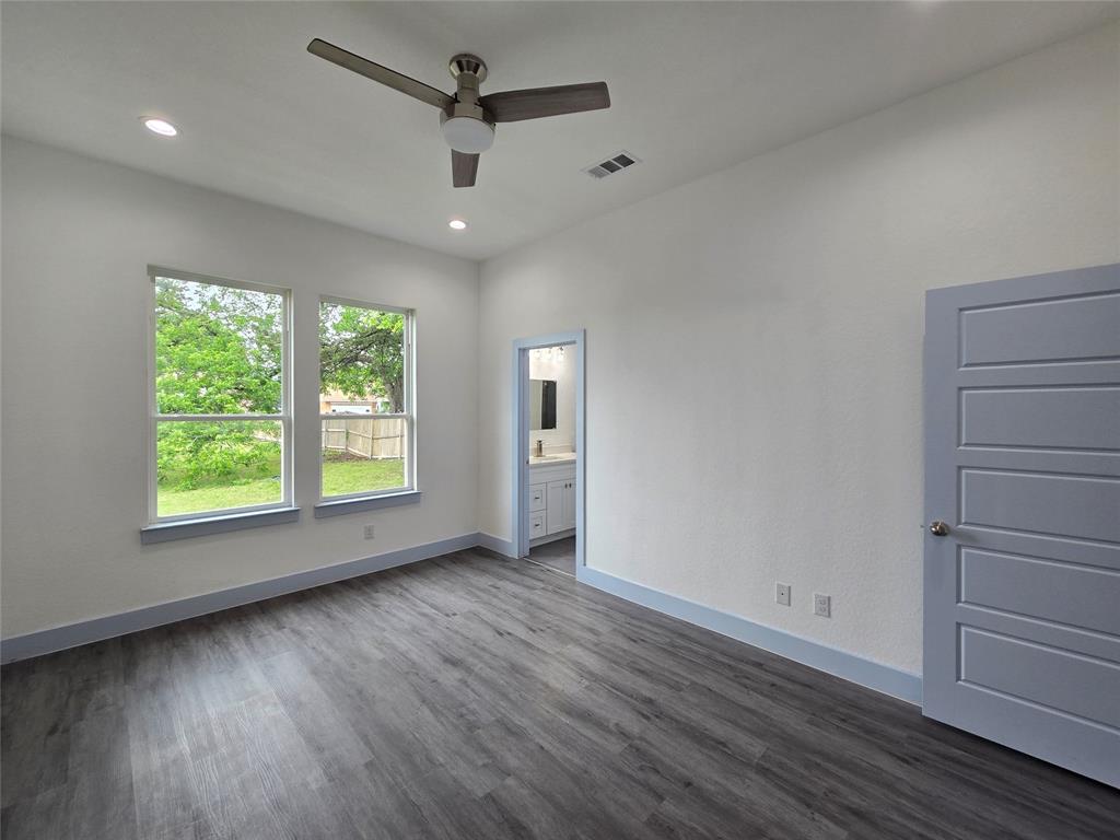 3202 Noor Street Dallas, TX 75233 - Photo 10 of 20 an empty room with wooden floor and windows
