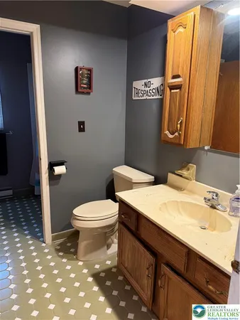 a bathroom with a toilet a sink and a mirror