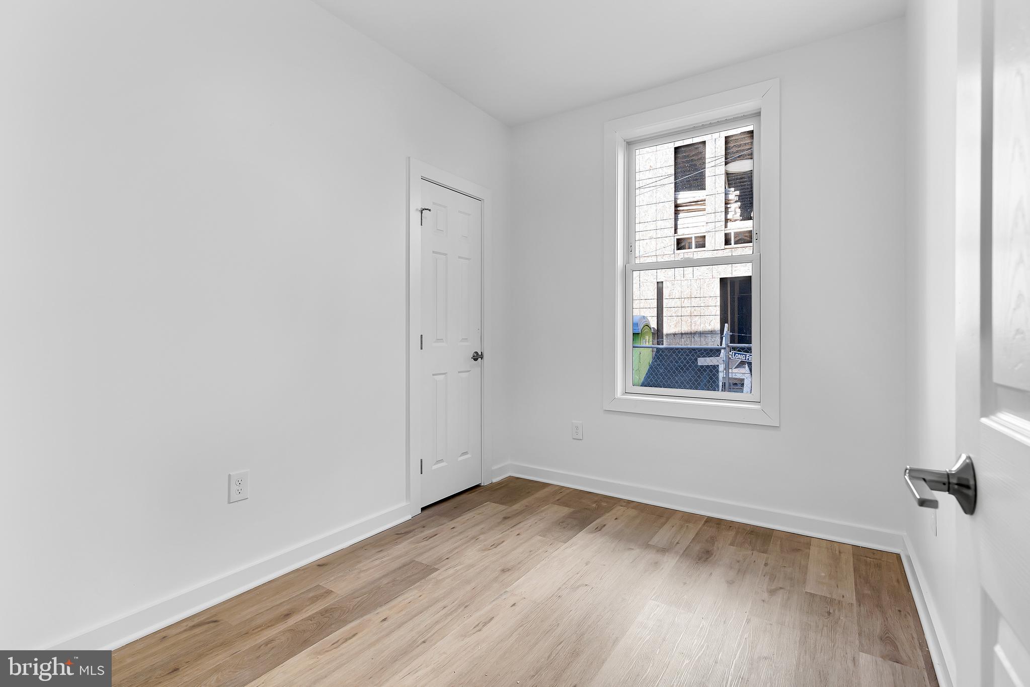 1712 3rd Street Northwest Washington, DC 20001 - Photo 11 of 32 an empty room with wooden floor and windows