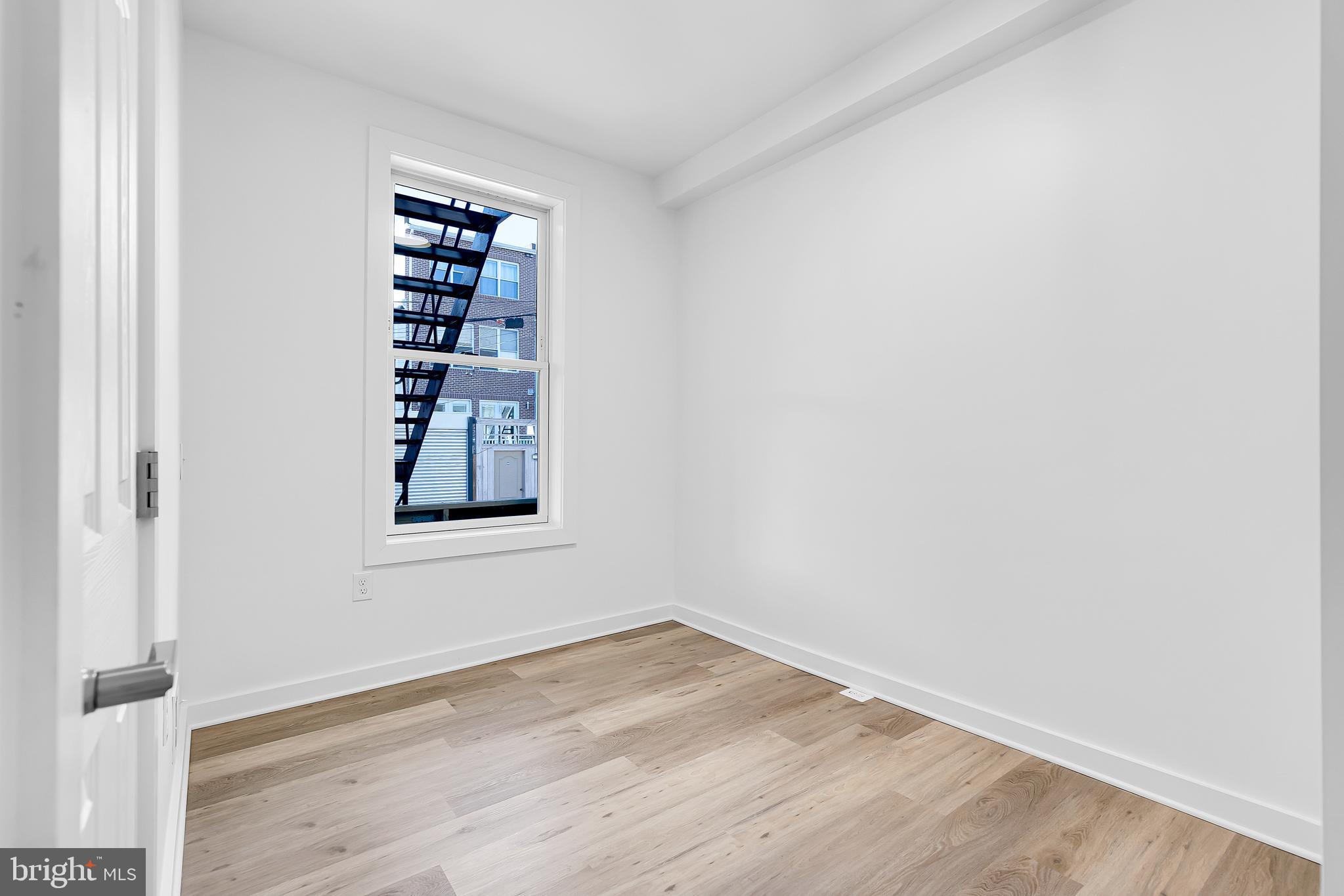 1712 3rd Street Northwest Washington, DC 20001 - Photo 12 of 32 an empty room with wooden floor and windows