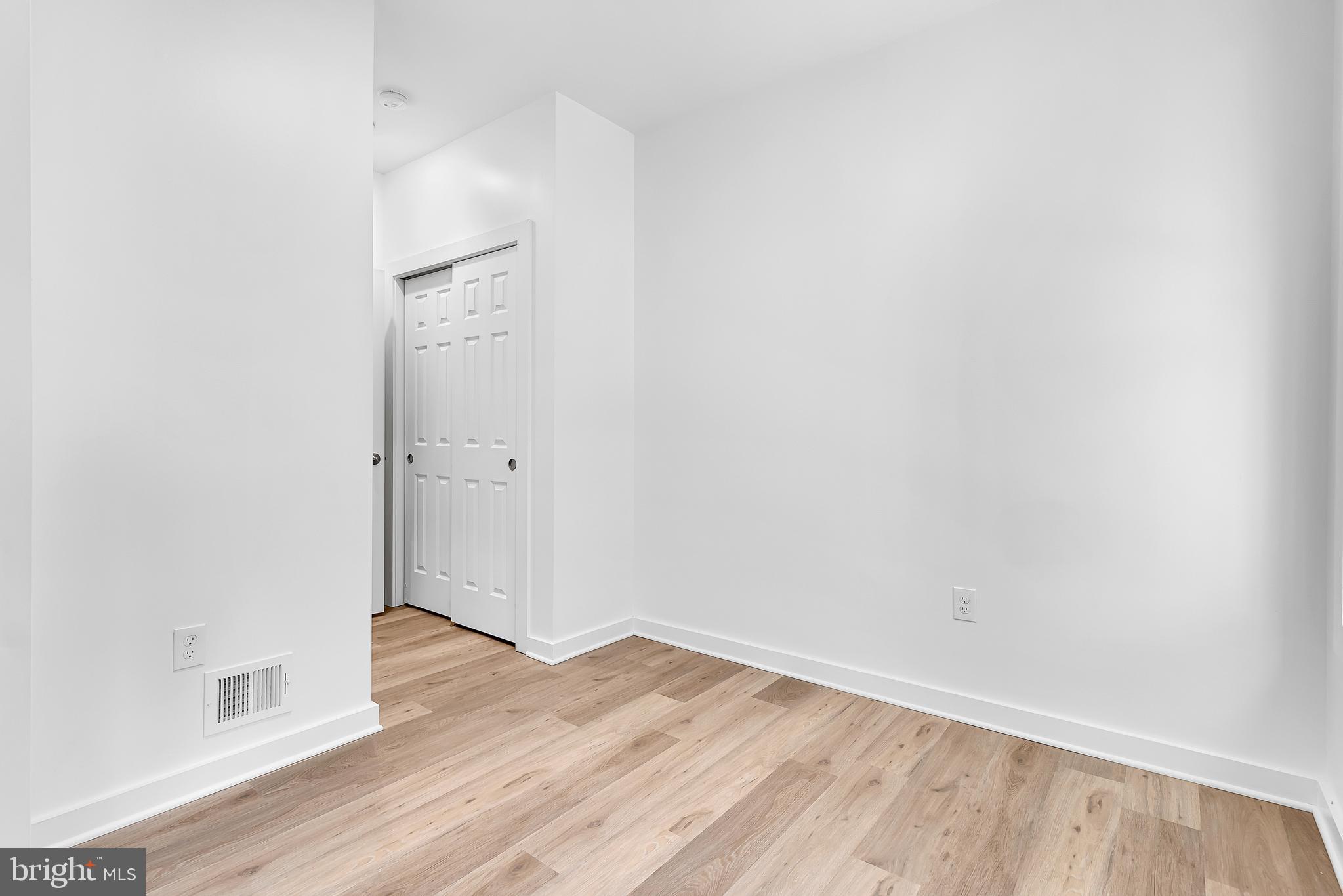 1712 3rd Street Northwest Washington, DC 20001 - Photo 14 of 32 an empty room with wooden floor and white walls
