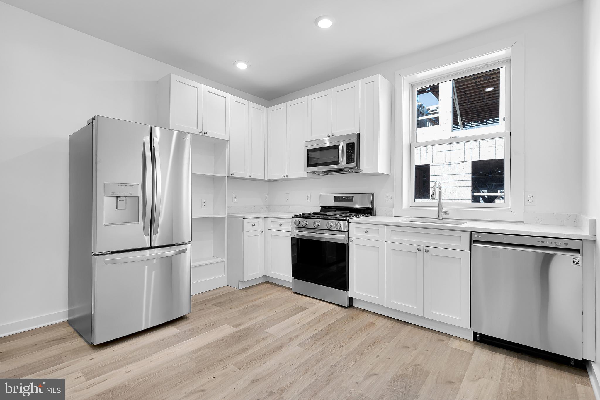 1712 3rd Street Northwest Washington, DC 20001 - Photo 17 of 32 a kitchen with stainless steel appliances a refrigerator sink and microwave