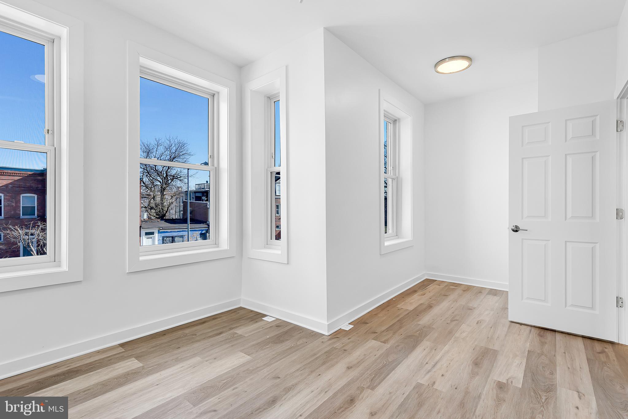 1712 3rd Street Northwest Washington, DC 20001 - Photo 20 of 32 a view of an empty room with wooden floor and a window