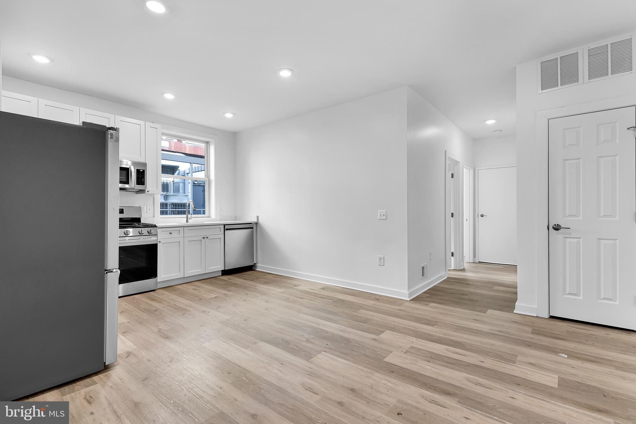 1712 3rd Street Northwest Washington, DC 20001 - Photo 4 of 32 a view of kitchen with granite countertop cabinets and refrigerator