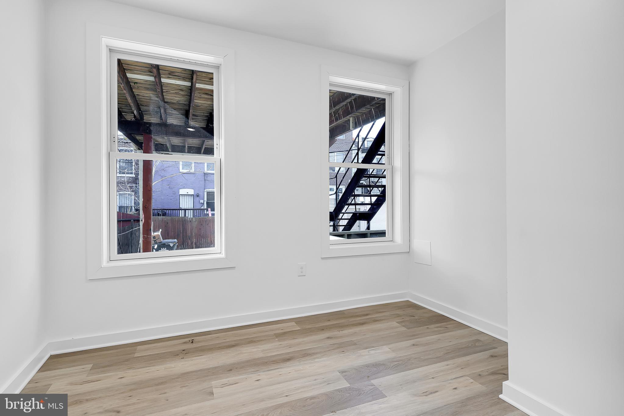 1712 3rd Street Northwest Washington, DC 20001 - Photo 5 of 32 an empty room with wooden floor and window