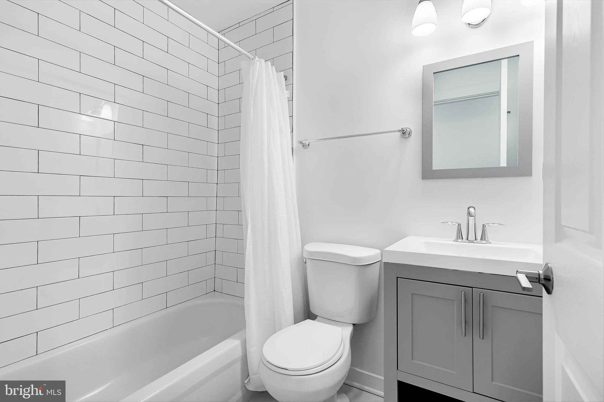 1712 3rd Street Northwest Washington, DC 20001 - Photo 8 of 32 a bathroom with a sink a toilet and shower