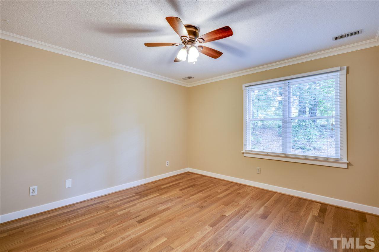 1401 Quarter Point Raleigh, NC 27615 - Photo 14 of 25 an empty room with wooden floor and ceiling fan
