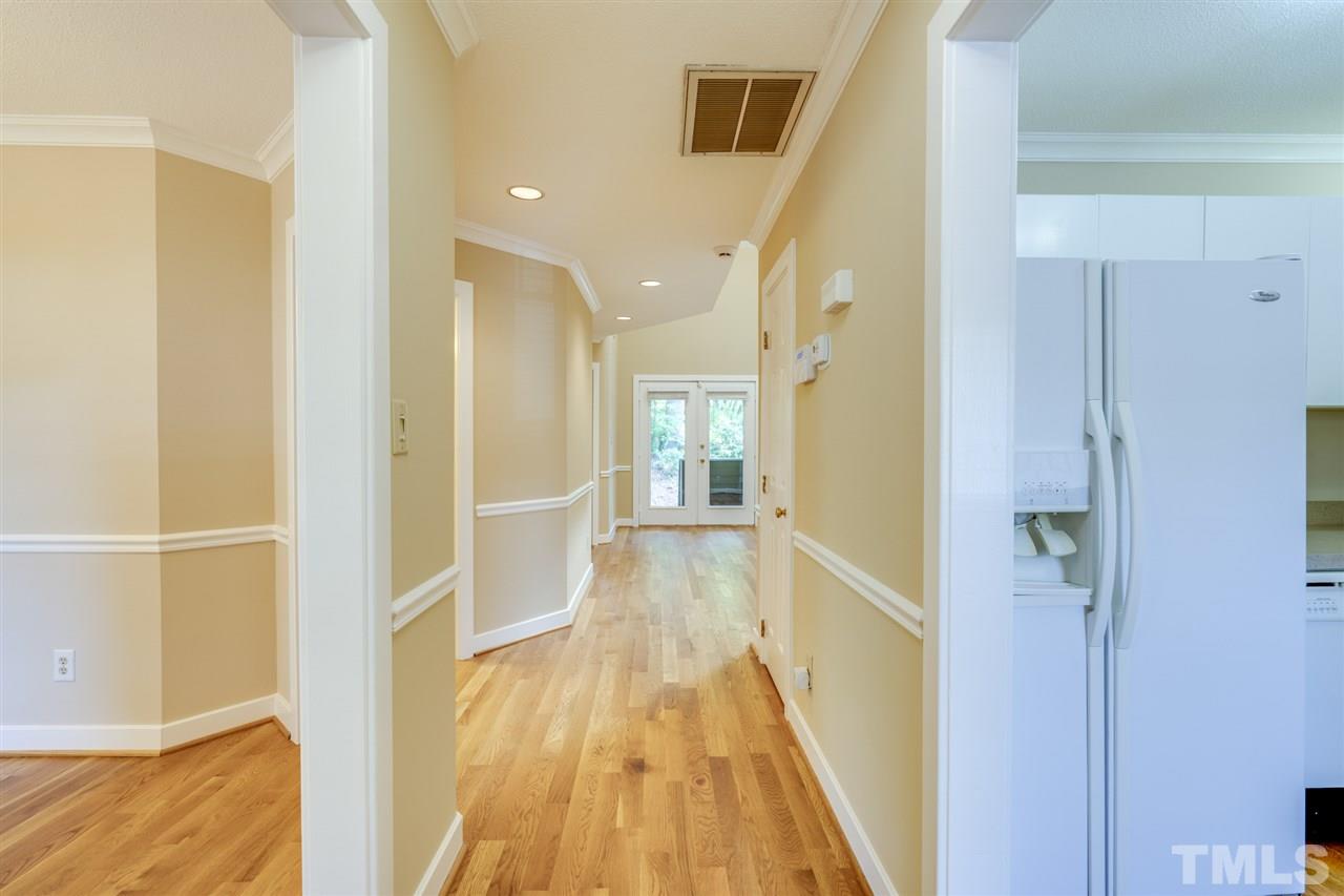 1401 Quarter Point Raleigh, NC 27615 - Photo 3 of 25 a view of a hallway with wooden floor and staircase