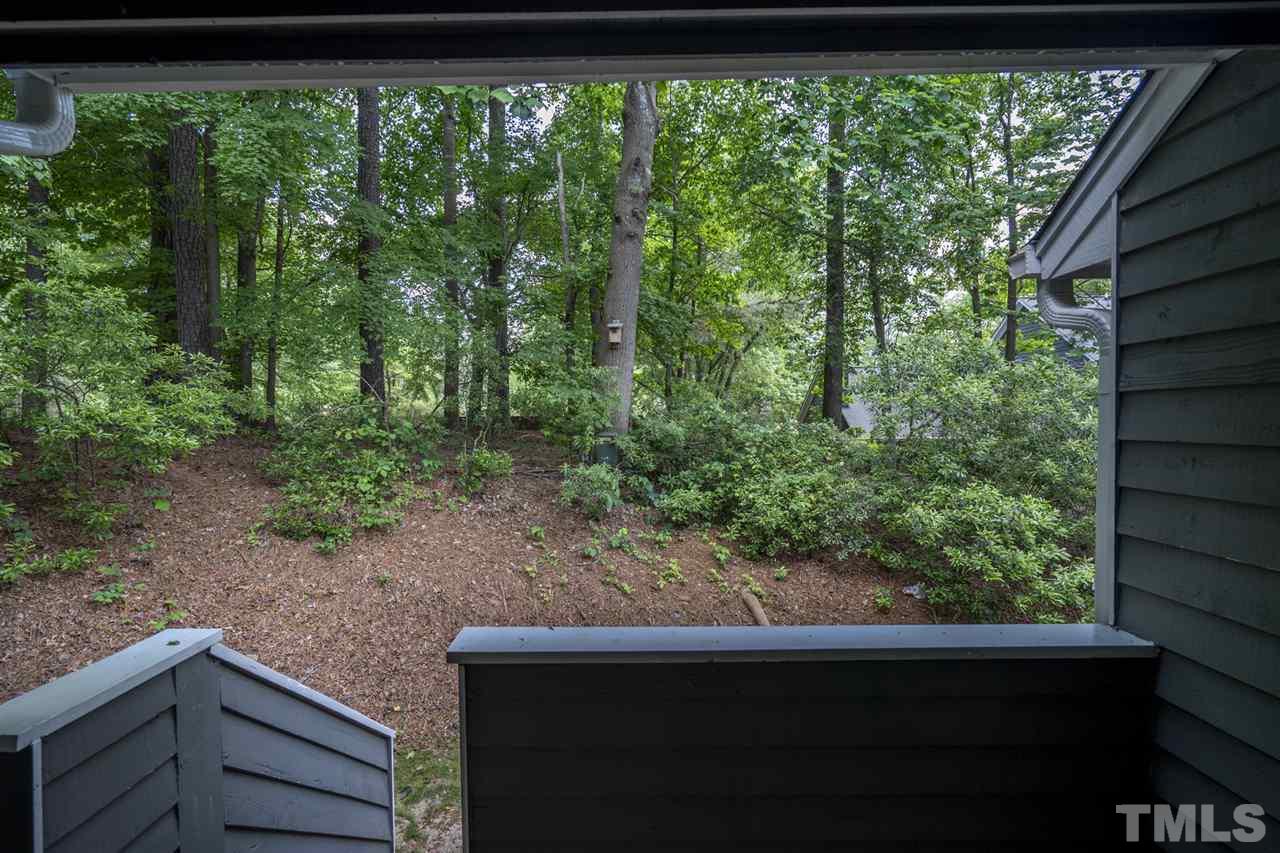 1401 Quarter Point Raleigh, NC 27615 - Photo 23 of 25 a view of a green field with trees in the background