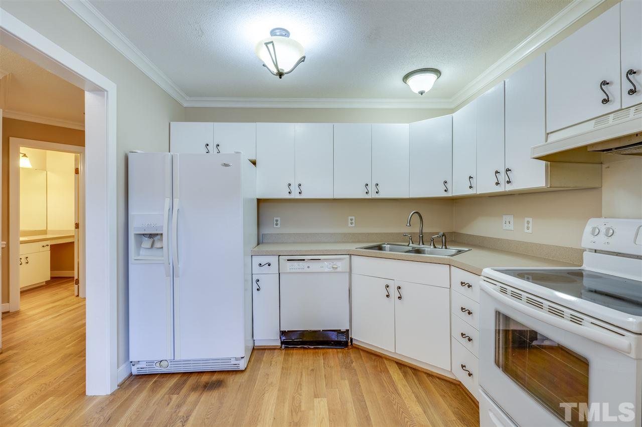 1401 Quarter Point Raleigh, NC 27615 - Photo 4 of 25 a kitchen with a sink a stove and cabinets