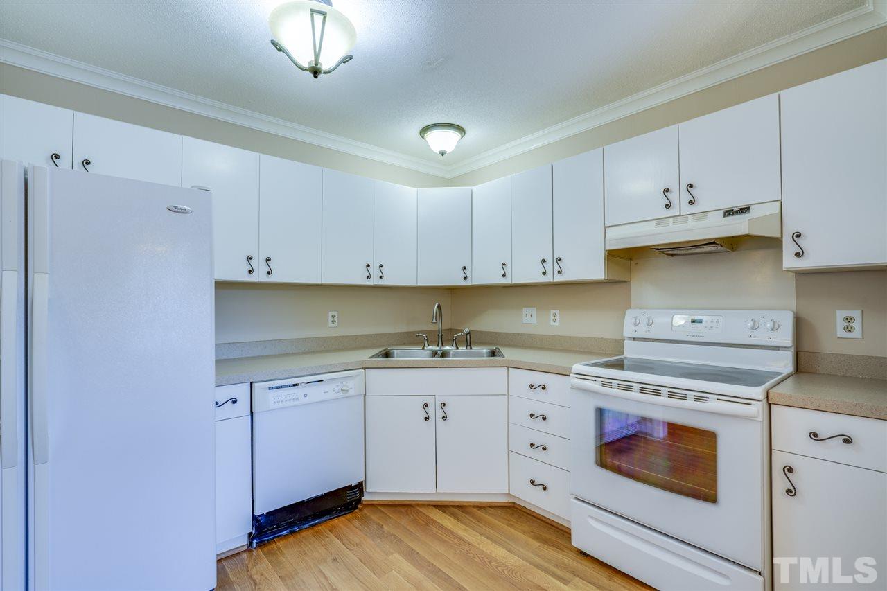 1401 Quarter Point Raleigh, NC 27615 - Photo 5 of 25 a kitchen with granite countertop white cabinets and white appliances