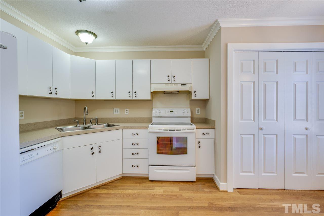 1401 Quarter Point Raleigh, NC 27615 - Photo 6 of 25 a kitchen with stainless steel appliances granite countertop a stove a sink and white cabinets