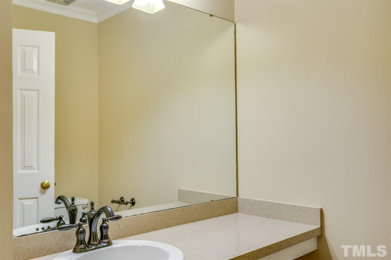1401 Quarter Point Raleigh, NC 27615 - Photo 10 of 25 a bathroom with a sink and a mirror