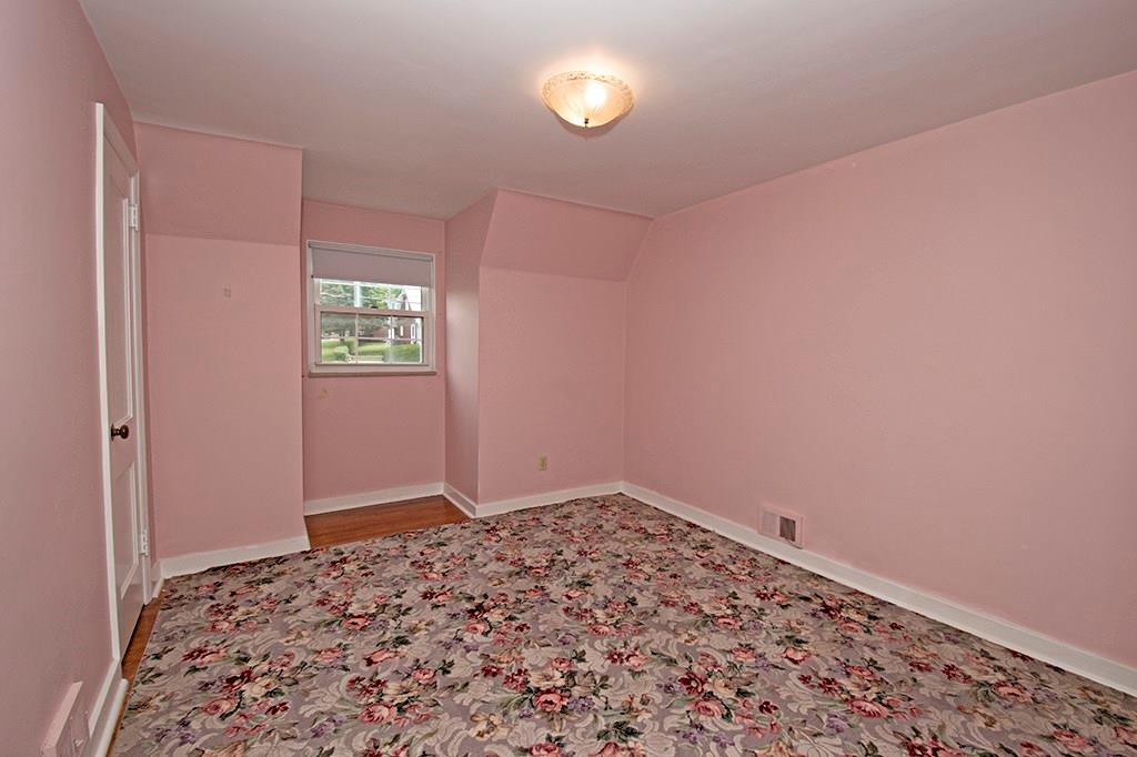 2854 Leechburg Road Lower Burrell, PA 15068 - Photo 21 of 25 Bedroom 2 - the hardwood floors can be seen at the edge of the area rug.