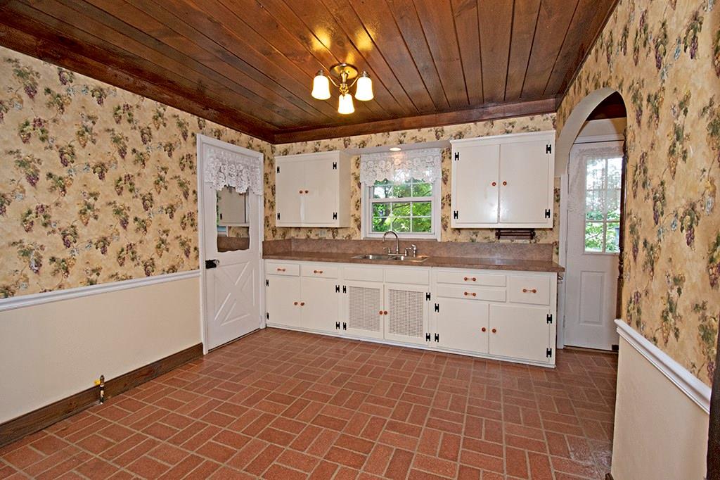 2854 Leechburg Road Lower Burrell, PA 15068 - Photo 8 of 25 Colonial styled kitchen features wood cabinetry and a lovely wood ceiling. The door on the left is to the garage.