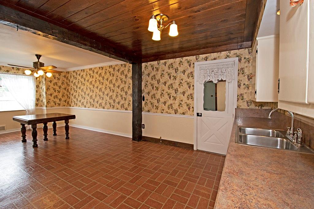 2854 Leechburg Road Lower Burrell, PA 15068 - Photo 9 of 25 One huge room for kitchen and dining accented by the wood beams, chair rail, crown molding and the wood ceiling.