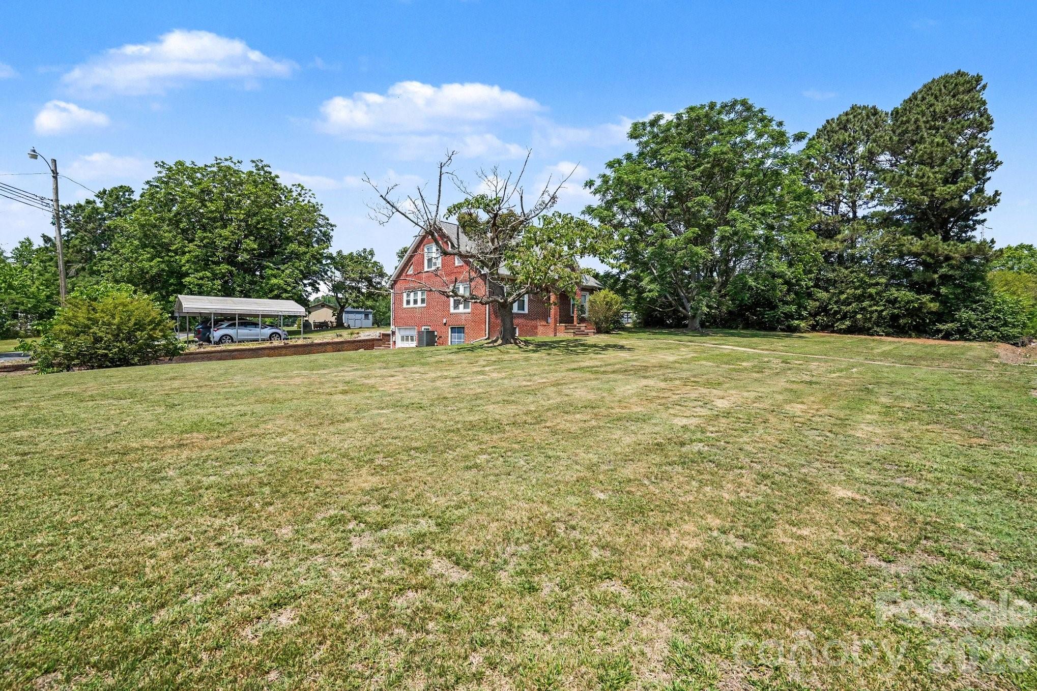 24359 Ridgecrest Road Locust, NC 28097 - Photo 24 of 26 a view of a field with trees in the background